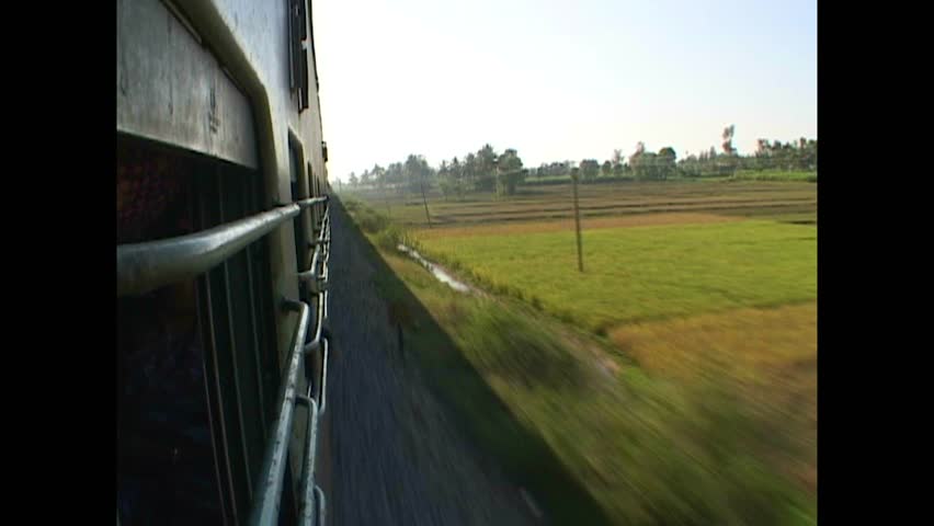 INDIA - 1999 - View from the side of a train as it travels through the Indian countryside. Royalty-Free Stock Footage #3460620639