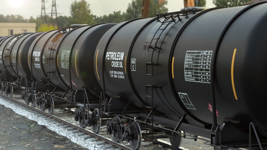 A long railroad train with tank wagons of diesel fuel and petroleum products moving slowly through an oil refinery. Great demand for fuel and shortages around the world. Loopable 3d animation.