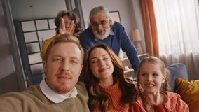 Blonde father taking happy family selfie while his wife, daughter and parents making bunny ears to each other. Playful people making silly faces and having fun while posing for memory photo. - Powered by Shutterstock - Get 15% off with code: PIKWIZARD15