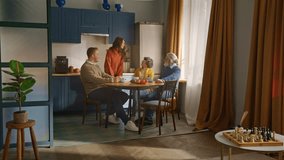 Distant view on brunette woman in orange sweater standing by table and leaning for embracing elderly woman. Household gathering ending with female expressing affection to hearty mother-in-law. - Powered by Shutterstock - Get 15% off with code: PIKWIZARD15