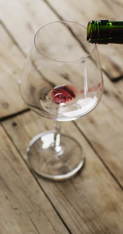 Vertcal video of red wine pouring into glass. Wine, alcohol, beverages, wine tasting and relax concept.