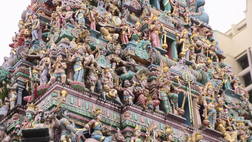 colorful display of hindu gods on top of a temple in the Little India neighborhood of downtown Singapore in Asia