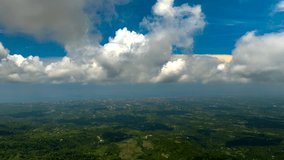 Hyperlapse timelapse of abstract white clouds moving in blue sky over Bali verdant landscape, Indonesia. Aerial drone panoramic view