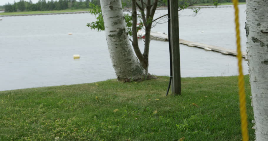 Young boy swings on baby swing - side profile