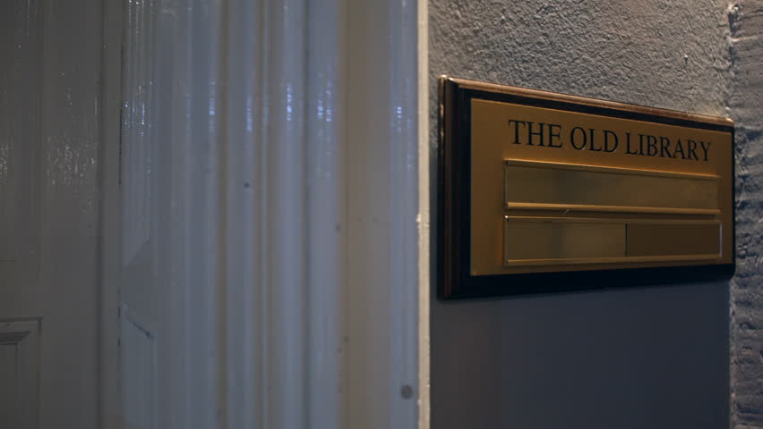 The Old Library sign in a manor house hotel outside a door