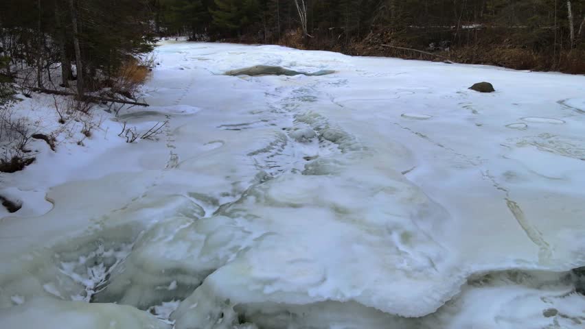 Aeria view of water falling down the frozen waterfall of Gooseberry Falls State Park.