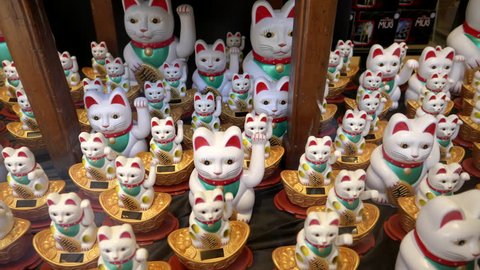 beckoning cat figurines in a store window of chinatown in san francisco, usa