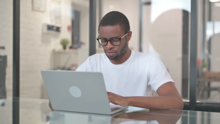 African American Man in Denial Looking at Camera in Office