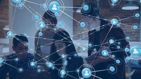 Animation of network of connections with people icons over diverse business people in office. Global finance, business, connections, computing and data processing concept digitally generated video. - Powered by Shutterstock - Get 15% off with code: PIKWIZARD15