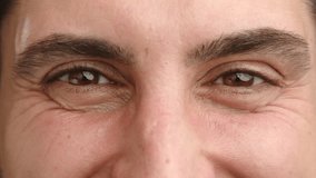 A close-up portrait focused on the eyes of a smiling man, his gaze exuding warmth and friendliness, set against a neutral background. Camera 8K RAW.  - Powered by Shutterstock - Get 15% off with code: PIKWIZARD15