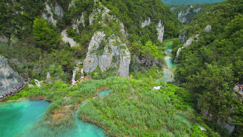 Plitvice waterfalls in mountain landscape of Croatia. Blue and green can be seen in the cascades. Water streams flow into a lake. Royalty-Free Stock Footage #3461145877