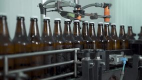Glassy beer bottles are moving along the factory transporter. Industrial alcohol business - Powered by Shutterstock - Get 15% off with code: PIKWIZARD15