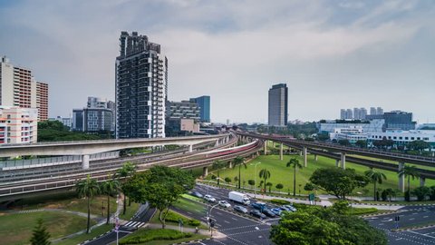 A day time lapse shot that depicts the transport system in Singapore. MRT, Subway, Train lines with busy roads and moving clouds.