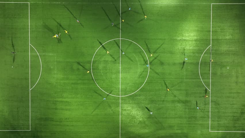 Aerial Top Down View of Soccer Football Field and Two Professional Teams Playing. 