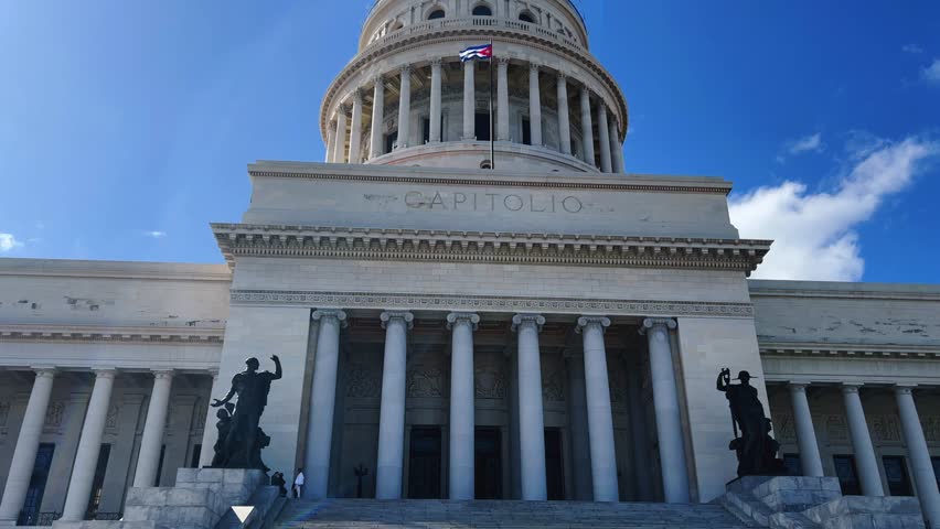 The famous building of the National Capitol in Cuba. HAVANA - DECEMBER 20, 2023: The entrance staircase and the dome of the Capitol in the center of Havana against the background of a blue sunny sky.