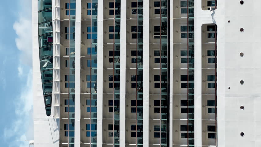 Decks with balconies of a huge cruise ship located in the port of Monaco, deck chairs on the balcony of each cabin