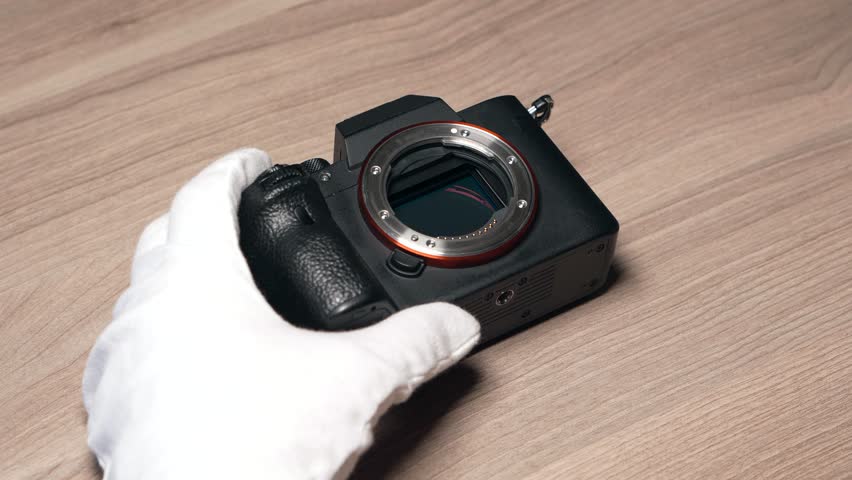 Cleaning a modern digital full-frame camera sensor using a sensor swab Royalty-Free Stock Footage #3461319121