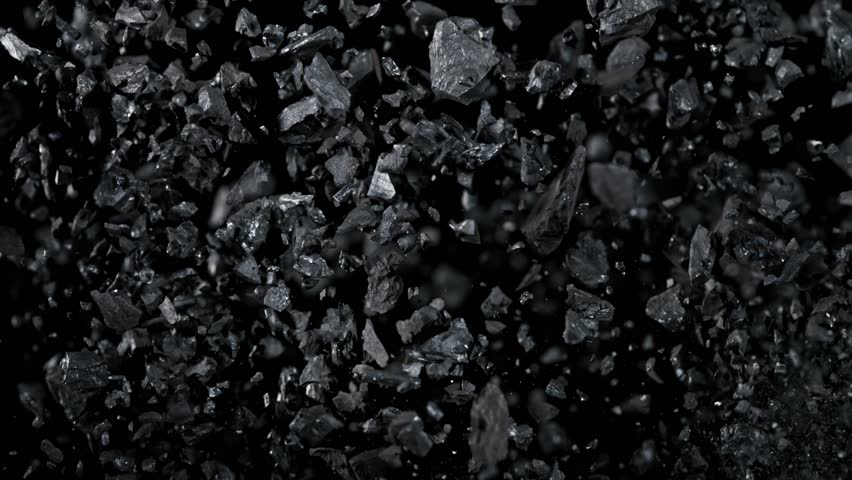 Super Slow Motion Shot of Coal Pieces Flying Up at 1000 fps.