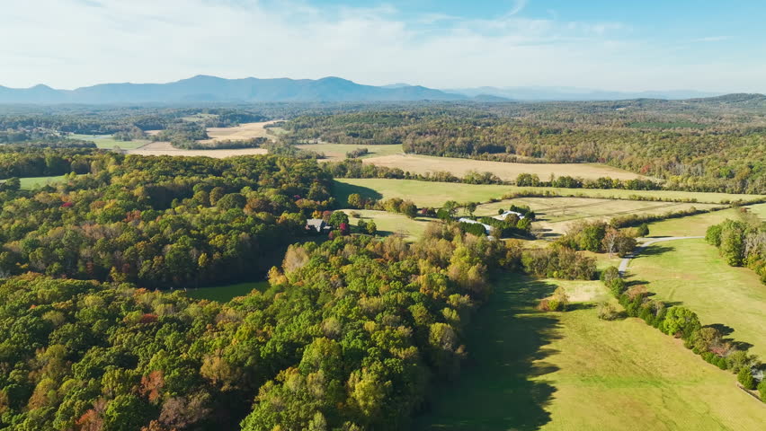 North Carolina countryside. Large expensive farmhouse surrounded with farm fields and dense woods close to Appalachian mountains