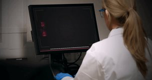 Animation of data processing over caucasian female scientist using computer in laboratory. Global science, connections, computing and data processing concept digitally generated video.