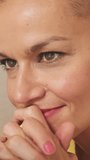 Vertical video, Close-up portrait of bald smiling woman using laptop in living room