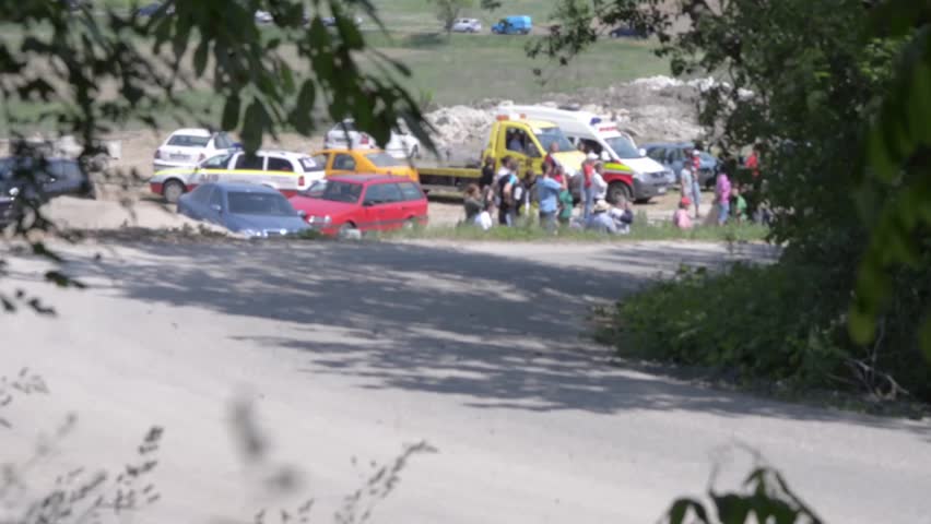 white rally car turns to the left in a curve 34b
