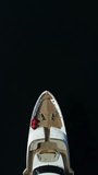 Yacht on calm sea. Luxury cruise trip. Side view of white boat on deep blue water. Aerial view of rich yacht sailing sea. Summer journey on luxury ship. Vertical video
