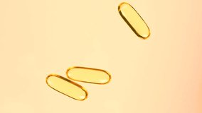 Omega3 capsules supplement yellow transparent capsule with fish, omega 6, omega 9, vitamin A, vitamin D, vitamin D3, vitamin E oil Cod liver oil. daily EPA and DHA dietary needs fatty acids.