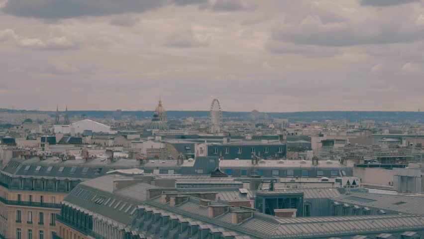 Paris roofs and Eiffel Tower. Beautiful roofs view in Paris City downtown with skyline under sunlight at day time.