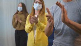 People medical masks applaud standing hospital corridor during epidemic. Doctors greetings echo as people applaud in appreciation of healthcare heroes. People medical masks - Powered by Shutterstock - Get 15% off with code: PIKWIZARD15