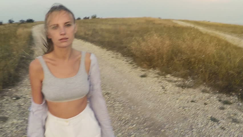 the girl runs along the stony road