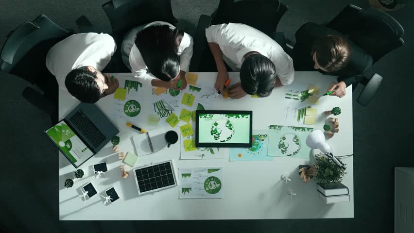 Top view of executive manager hold tablet display clean energy at meeting. Aerial view of business people working together to plan and invest in sustainable environmental investment. Alimentation. Royalty-Free Stock Footage #3461883807