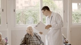 Doctor talking with a senior man in the nursing home