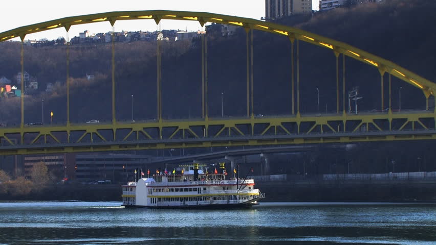 Riverboat passes under a bridge in Pittsburgh, PA.