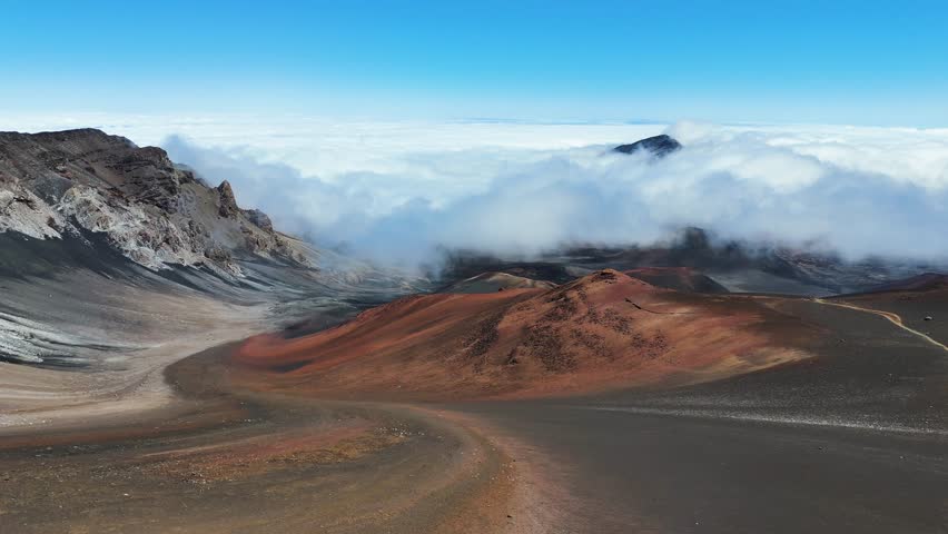 Haleakala Crater looms 10,023 feet above the Pacific Ocean, taking up three-quarters of Maui’s 727 square miles. Haleakala sunrise inspire 1.5 million visitors annually. Royalty-Free Stock Footage #3461956915