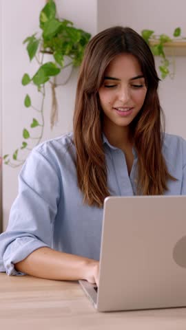 Happy business woman working on laptop computer from home. Technology and business people concept. Vertical HD footage.