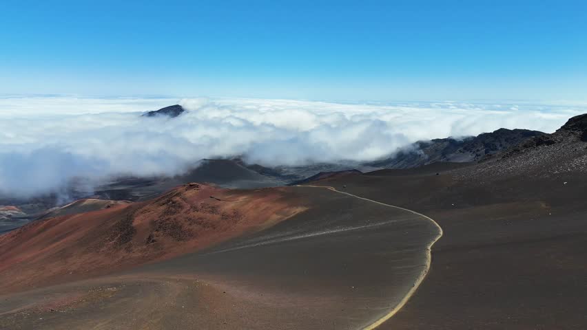 Haleakala Crater looms 10,023 feet above the Pacific Ocean, taking up three-quarters of Maui’s 727 square miles. Haleakala sunrise inspire 1.5 million visitors annually. Royalty-Free Stock Footage #3461973507