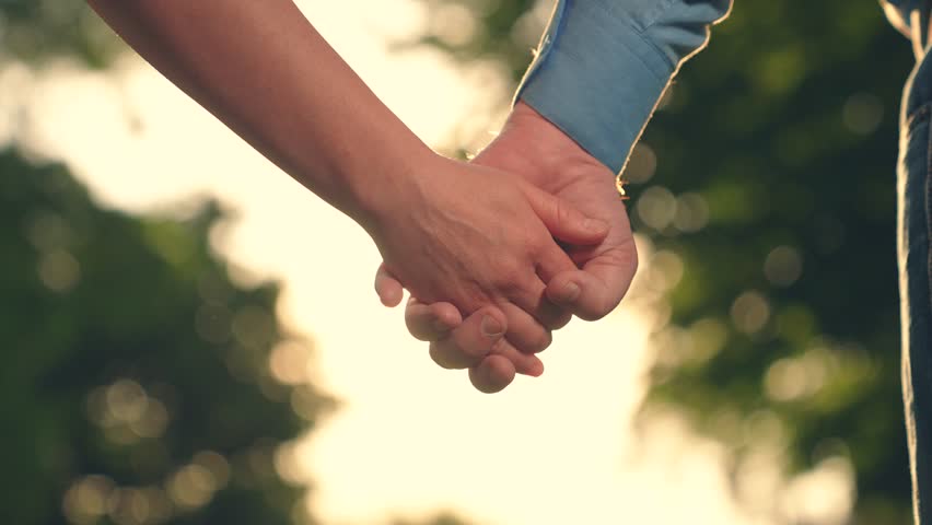 Separation, separation, quarrel. Closeup of guy lets go of girls hand, separation. Pair of man, woman separate their hands in front of sun. Separation of hands of man of woman. Family at sunset Royalty-Free Stock Footage #3461975459