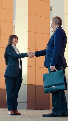 Business woman shaking hands with partner, successful cooperation under contract. Businessmen in suits greet on street with hand gestures. Politicians. Business people shaking hands, working as team. Royalty-Free Stock Footage #3461978963