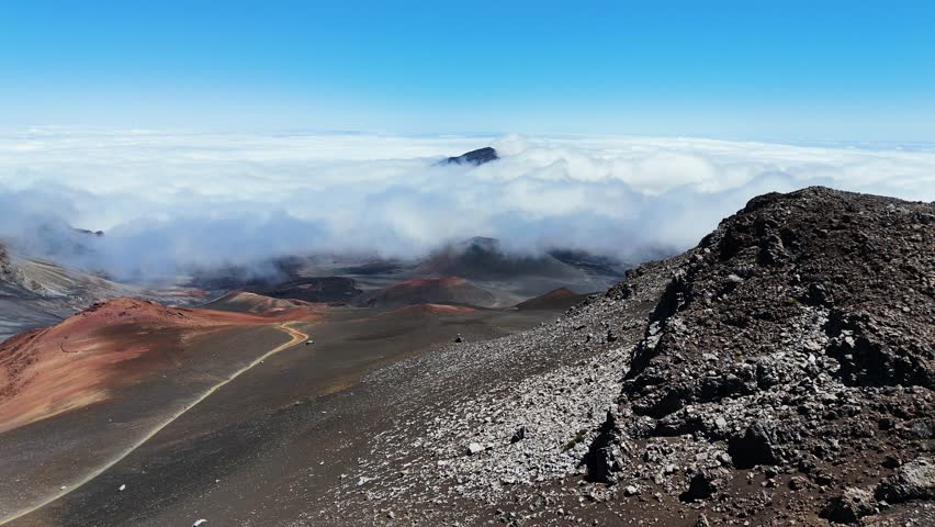 Haleakala Crater looms 10,023 feet above the Pacific Ocean, taking up three-quarters of Maui’s 727 square miles. Haleakala sunrise inspire 1.5 million visitors annually. Royalty-Free Stock Footage #3461979665