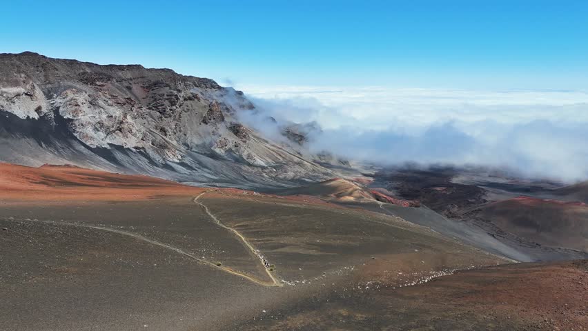 Haleakala Crater looms 10,023 feet above the Pacific Ocean, taking up three-quarters of Maui’s 727 square miles. Haleakala sunrise inspire 1.5 million visitors annually. Royalty-Free Stock Footage #3461985153