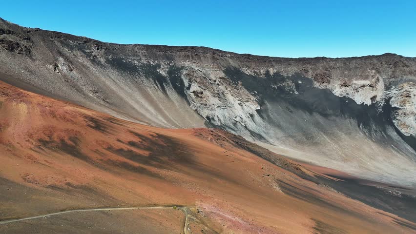 Haleakala Crater looms 10,023 feet above the Pacific Ocean, taking up three-quarters of Maui’s 727 square miles. Haleakala sunrise inspire 1.5 million visitors annually. Royalty-Free Stock Footage #3461987795