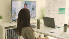 Professional discussing sustainability strategies on a video call in a modern office setting with ESG data visuals. - Powered by Shutterstock - Get 15% off with code: PIKWIZARD15