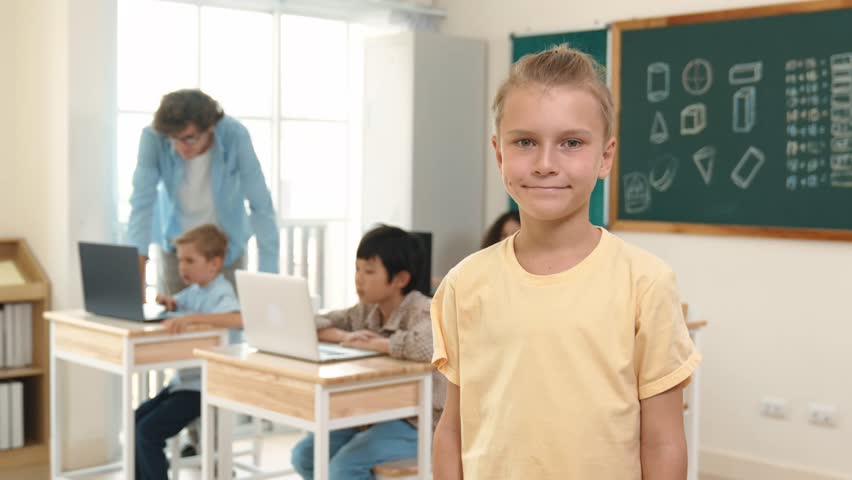 Caucasian cute student looking at camera while friend studying about writing engineering code or coding prompt. Professional smart teacher checking prompt while teaching about AI generated. Pedagogy. Royalty-Free Stock Footage #3462066537