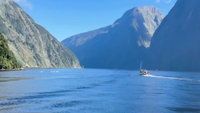 Milford Sound Fiordland National Park New Zealand, Fishing Boat Charter Cruise Sightseeing Experience Mitre Peak Rainforests Waterfalls Cliffs Mountains Hills Peaks Valley Sailing Tourists Tourism Royalty-Free Stock Footage #3462069881
