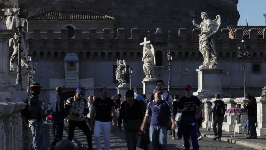 ROME - CIRCA MAY 2012: Tourists mill around the Ponte Sant'Angelo, with angel