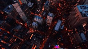 Top Down aerial video of Downtown, revealing the city lights and roads. An aerial flying towards he city video shot in down town, San Francisco, revealing the roads and city lights , after sunset 