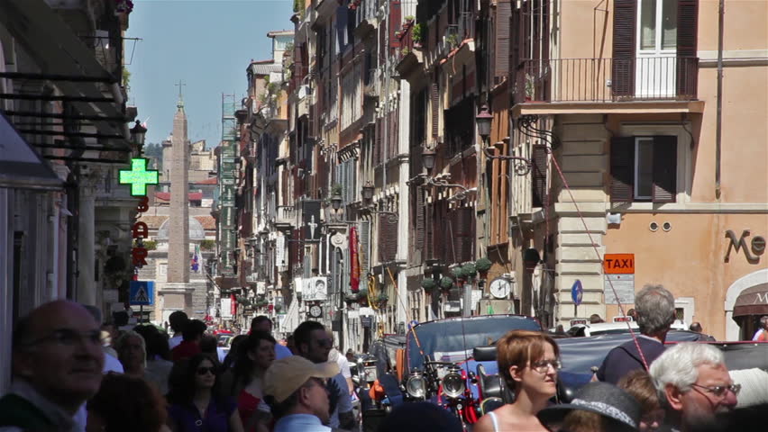 ROME - CIRCA MAY 2012: View down a street of Rome, where an obelisk stands. Cars