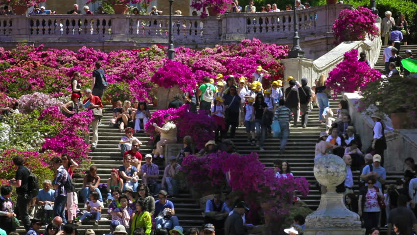 ROME - CIRCA MAY 2012: Pan of tourists and flowers on the Spanish Steps