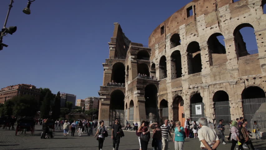 ROME - CIRCA MAY 2012: Tourists roam the exterior of the Colosseum on a sunny